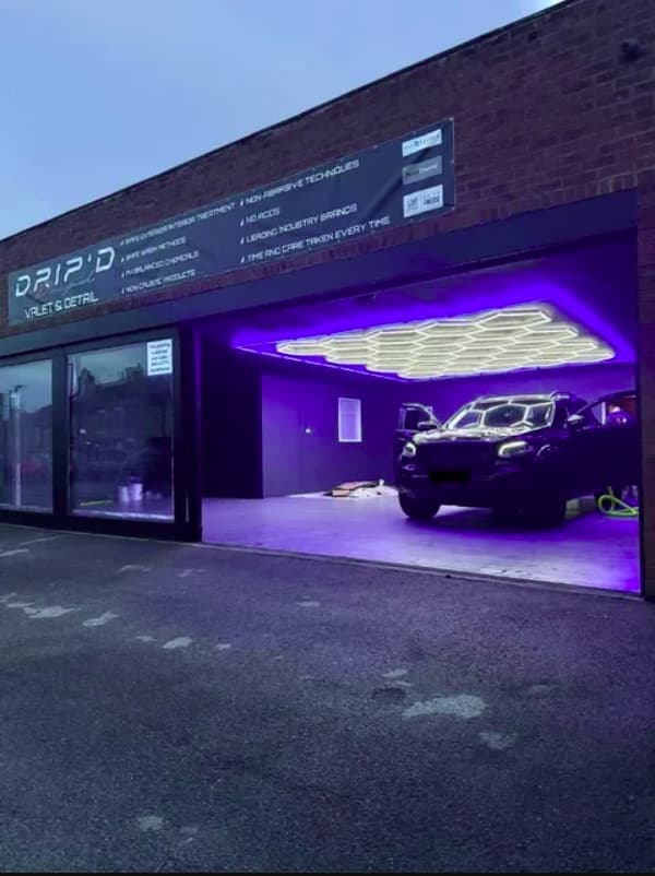 The DRIP'D wash bay lit under hex lighting